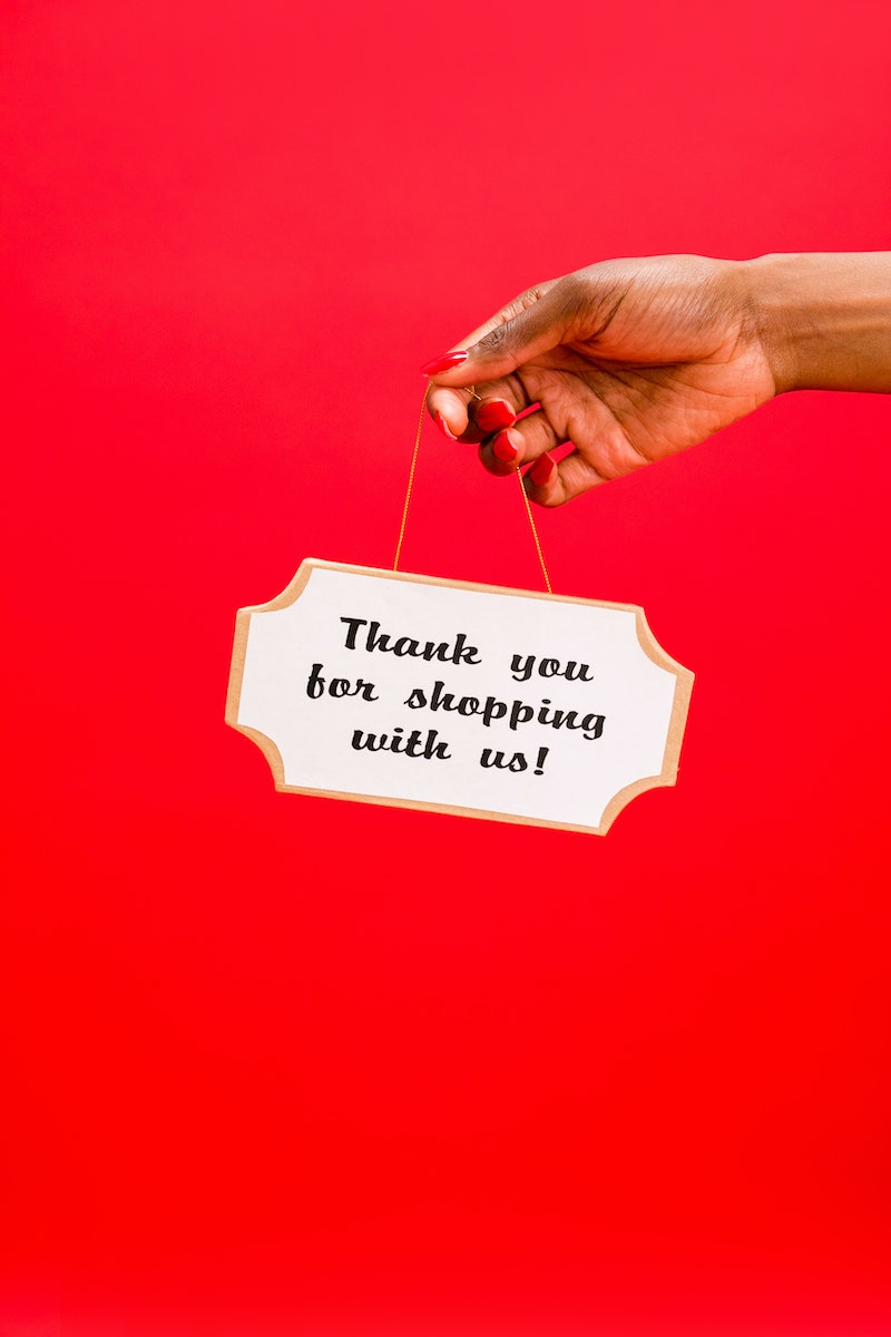 A Person Holding a Thank you for shopping with us Sign
