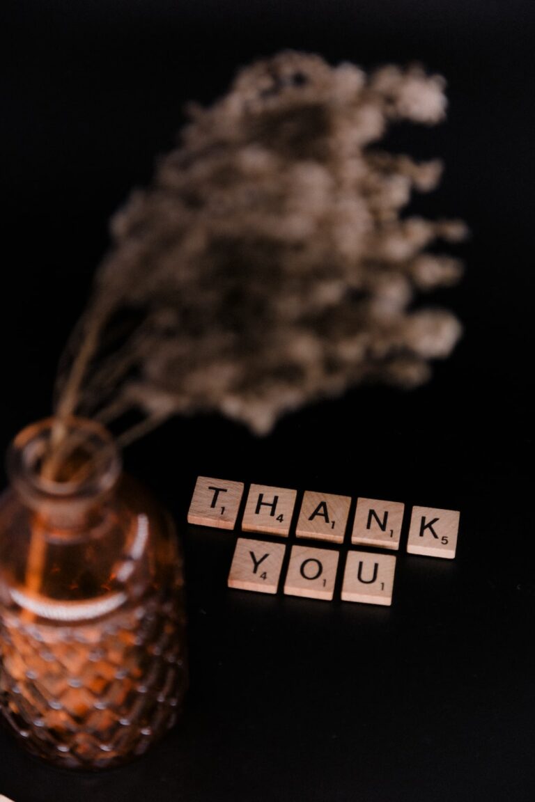 Clear glass bottle with white flowers and Thank You pieces 2