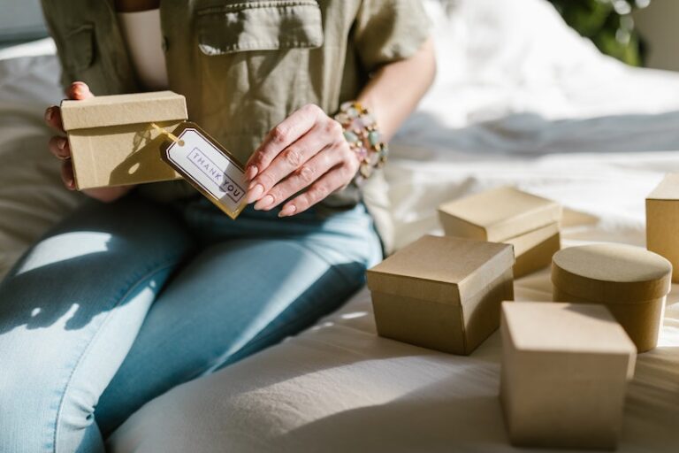 Close Up Shot of a Woman Holding a Box with Thank You Card