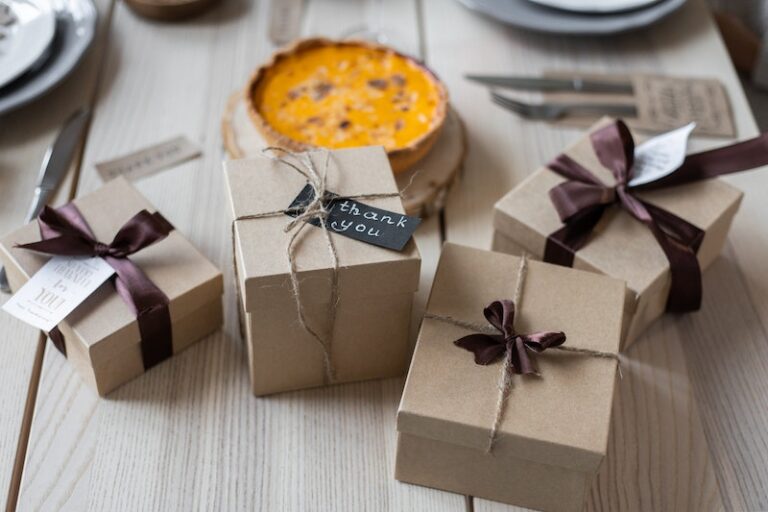 Gift boxes on table near pie with Thank You Note