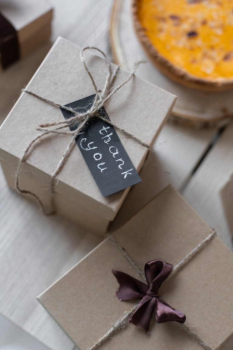 Gift boxes on table tied with ropes with thank you note