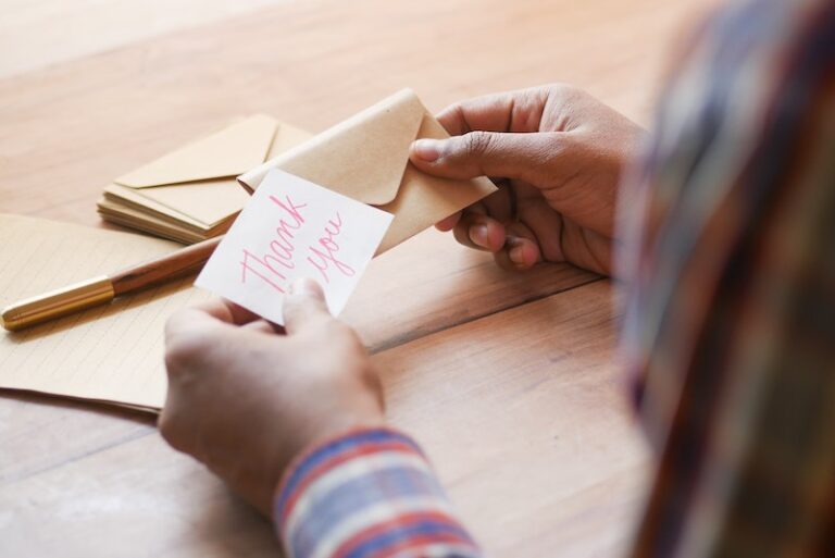 Hands Holding Thank you Note and Envelope