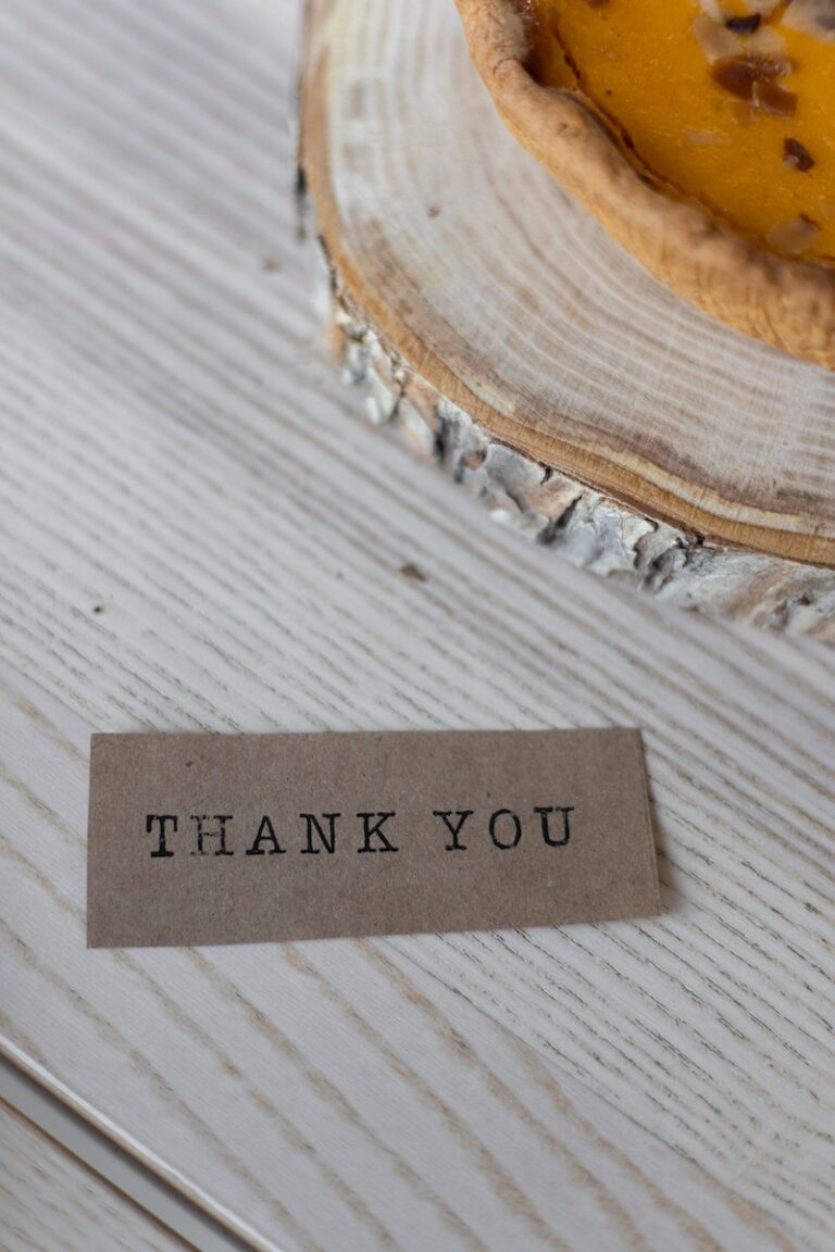 Paper with Thank You inscription on table