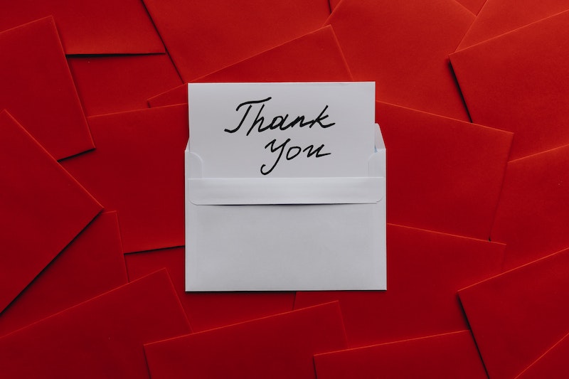 Thank You Card on Top of Red Envelopes